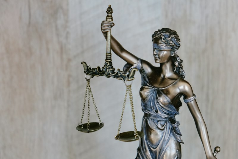 Legal documents beside a laptop