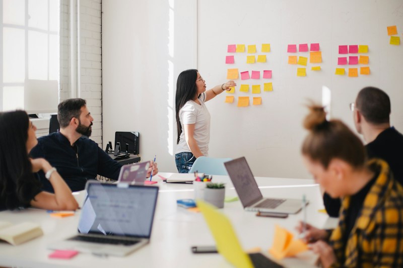 A team planning strategy at a whiteboard