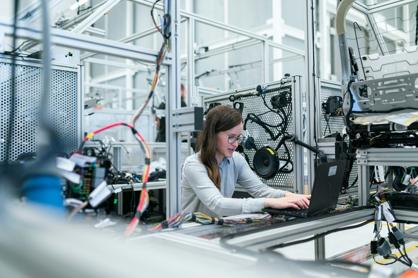 Engineer monitoring systems on a modern factory floor