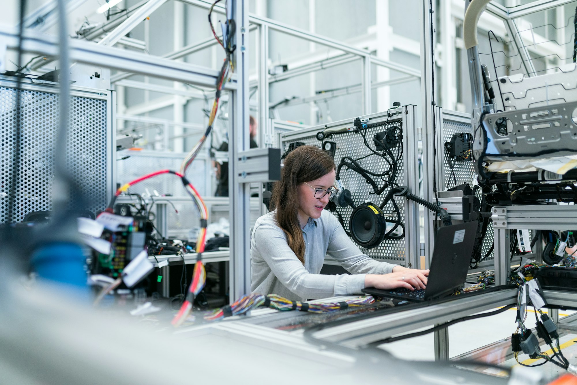 Engineer monitoring systems on a modern factory floor